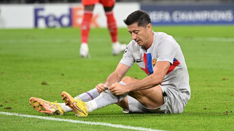 Barcelona&#39;s Robert Lewandowski sits on the pitch