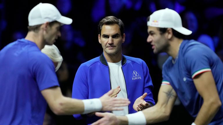 Team Europe's Roger Federer, center, looks at Andy Murray, left, and Matteo Berrettini during a match against Team World's Jack Sock and Felix Auger-Aliassime on final day of the Laver Cup tennis tournament at the O2 in London, Sunday, Sept. 25, 2022. (AP Photo/Kin Cheung)