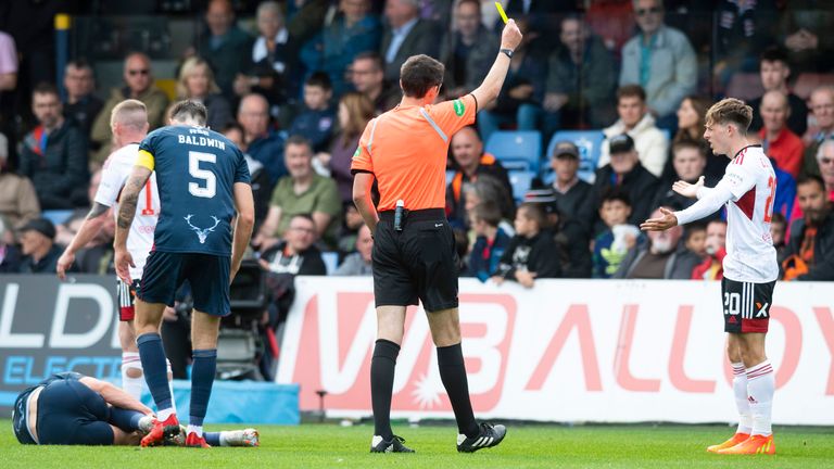 DINGWALL, SCOTLAND - SEPTEMBER 03: Aberdeen's Leighton Clarkson is booked for a challenge on Ross County's Callum Johnson during a cinch Premiership match between Ross County and Aberdeen at the Global Energy Stadium, on September 03, 2022, in Dingwall, Scotland.  (Photo by Mark Scates / SNS Group)