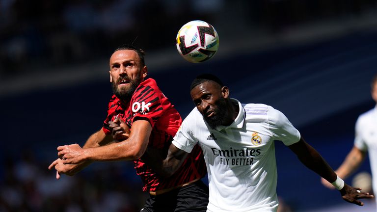 Real Madrid's Antonio Rudiger, right, and Mallorca's Vedat Muriqi, go for a header during the Spanish La Liga soccer match between Real Madrid and Mallorca at the Santiago Bernabeu stadium in Madrid, Spain, Sunday, Sept. 11, 2022. (AP Photo/Manu Fernandez)