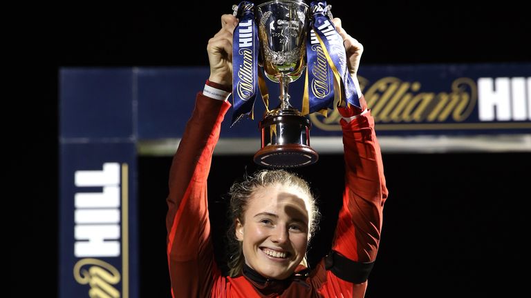 Saffie Osborne holds aloft the Racing League champion jockeys trophy