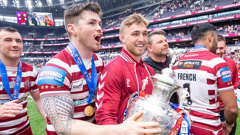 Picture by Allan McKenzie/SWpix.com - 28/05/2022 - Rugby League - Betfred Challenge Cup Final - Huddersfield Giants v Wigan Warriors - Tottenham Hotspur Stadium, London, England - Harry Smith, John Bateman & Sam Powell celebrate with the Challenge Cup trophy.