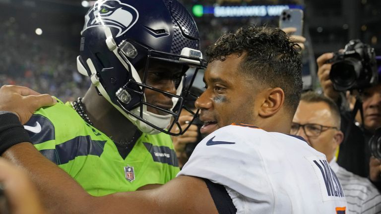 Seattle Seahawks quarterback Geno Smith, left, talks with Denver Broncos quarterback Russell Wilson, right, after an NFL football game, Monday, Sept. 12, 2022, in Seattle. The Seahawks won 17-16. (AP Photo/Stephen Brashear)