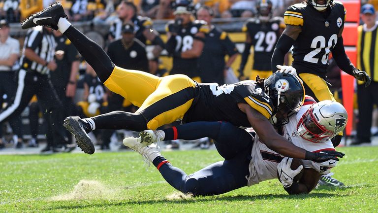 New England Patriots running back Damien Harris, bottom, is tackled by Pittsburgh Steelers linebacker Jamir Jones (48) during the second half of an NFL football game in Pittsburgh, Sunday, Sept. 18, 2022.