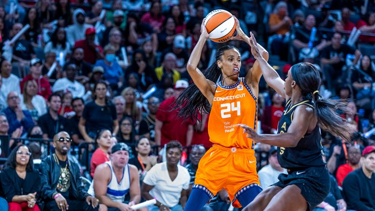 Connecticut Sun forward DeWanna Bonner looks to pass as Las Vegas Aces guard Jackie Young, right, defends during the second half in Game 1 of a WNBA basketball final playoff series Sunday, Sept. 11, 2022, in Las Vegas. 