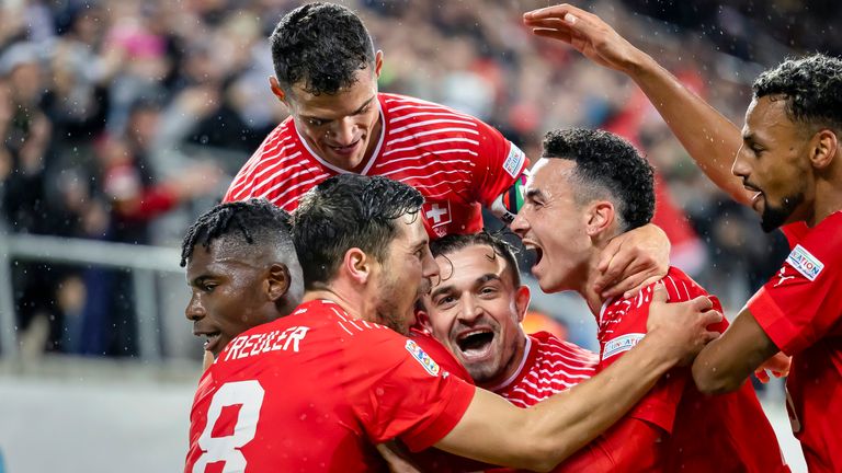 Switzerland's Breel Embolo, left, celebrates the win