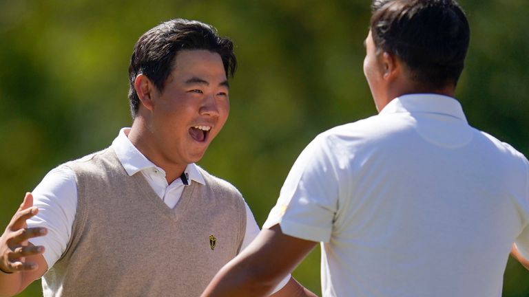 Tom Kim, of South Korea, left, and K.H. Lee, of South Korea, celebrate on the 17th green after winning their match during foursomes play at the Presidents Cup golf tournament at the Quail Hollow Club, Saturday, Sept. 24, 2022, in Charlotte, N.C. (AP Photo/Julio Cortez)