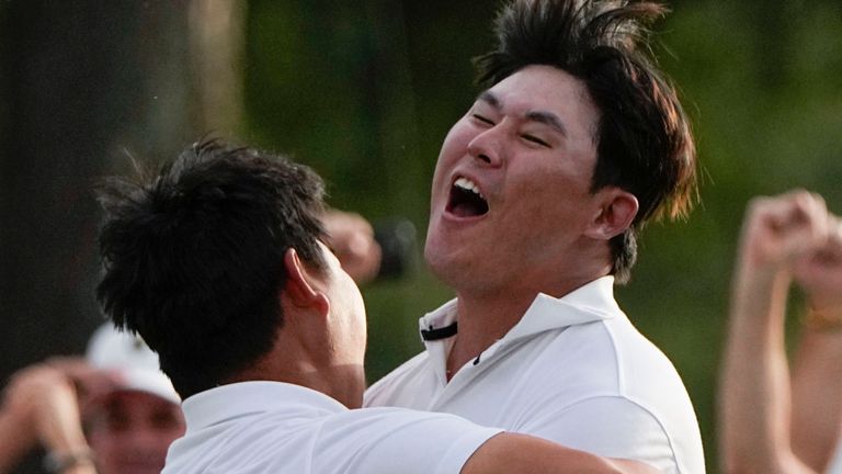 Tom Kim, of South Korea, left embraces teammate Si Woo Kim, of South Korea, after they won on the 18th hole during their fourball match at the Presidents Cup golf tournament at the Quail Hollow Club, Saturday, Sept. 24, 2022, in Charlotte, N.C. (AP Photo/Chris Carlson)