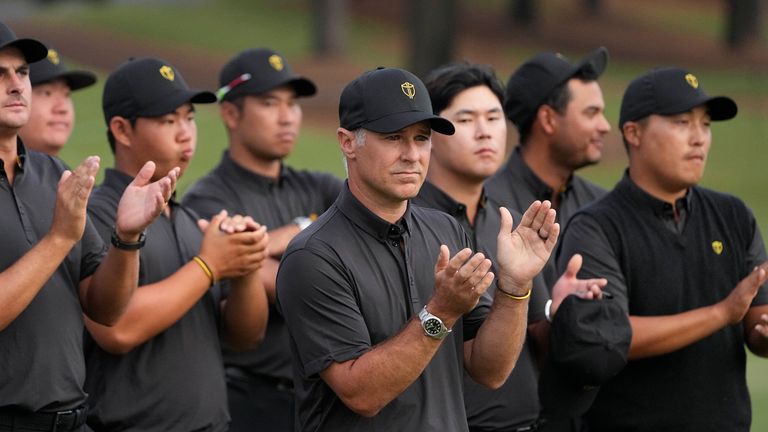 International team captain Trevor Immelman and the team celebrate the USA team's victory after a singles match at the Presidents Cup golf tournament at the Quail Hollow Club, Sunday, Sept. 25, 2022, in Charlotte, N.C. (AP Photo/Chris Carlson) 
