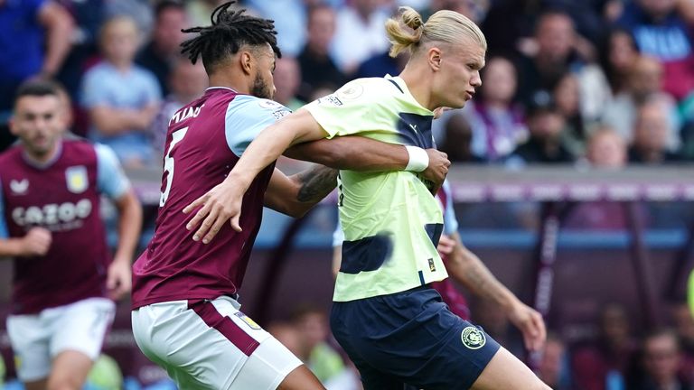 Tyrone Mings tussles with Erling Haaland at Villa Park