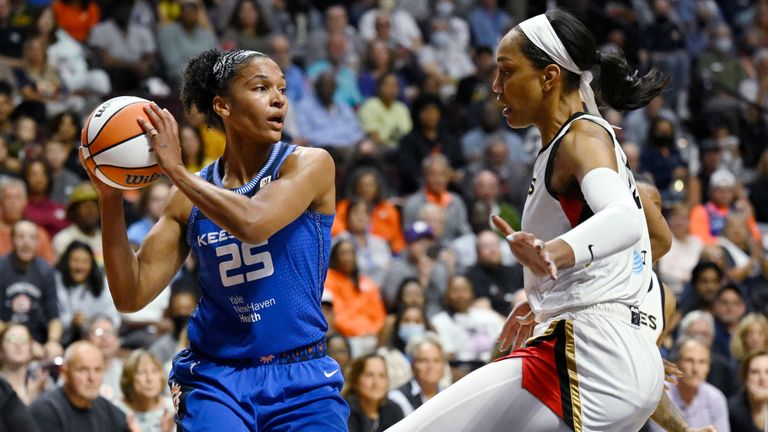 Connecticut Sun&#39;s Alyssa Thomas, left, looks to pass while Las Vegas Aces&#39; A&#39;ja Wilson defends during the first half in Game 3 of a WNBA basketball final playoff series, Thursday, Sept. 15, 2022, in Uncasville, Conn. (AP Photo/Jessica Hill)


