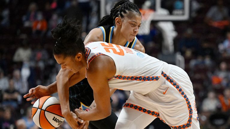 Chicago Sky forward Candace Parker, rear, fouls Connecticut Sun forward Alyssa Thomas during the second half of Game 4 of a WNBA basketball playoff semifinal Tuesday, Sept. 6, 2022, in Uncasville, Conn. (AP Photo/Jessica Hill)