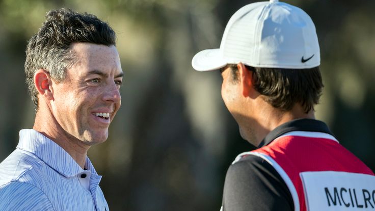 Rory McIlroy, left, of Northern Ireland, celebrates with his caddie after the final round of the CJ Cup golf tournament Sunday, Oct. 23, 2022, in Ridgeland, S.C. (AP Photo/Stephen B. Morton)