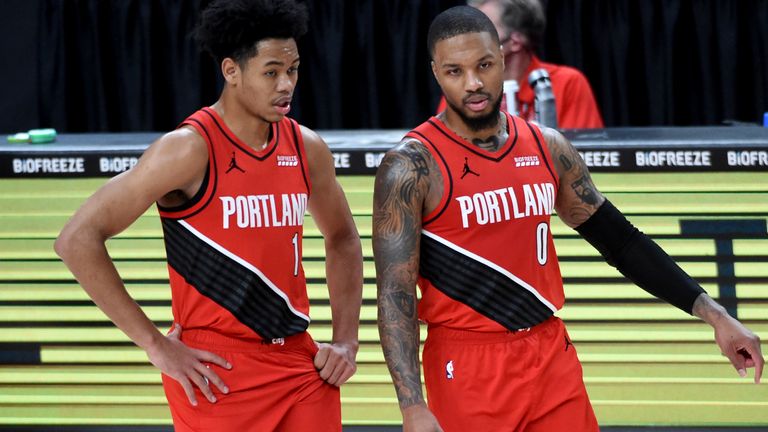 Anfernee Simons, left, and Damian Lillard have a chat on court for the Portland Trail Blazers
