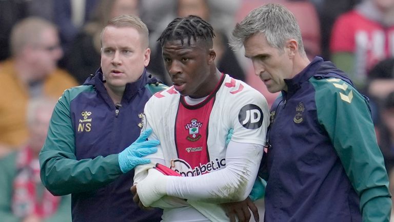 Southampton&#39;s Armel Bella-Kotchap is escorted from the pitch after an injury