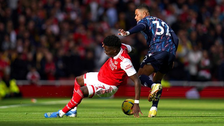 Arsenal's Bukayo Saka (left) and Nottingham Forest's Renan Lodi battle for the ball