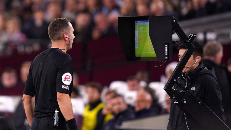 Referee David Coote consults his monitor