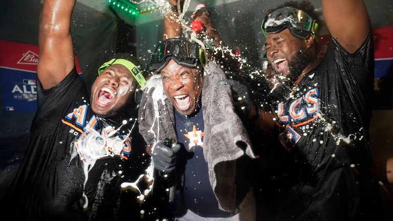 Houston Astros manager Dusty Baker Jr., center, celebrates with pitcher Hector Neris, left, and pitcher Cristian Javier, right, after defeating the Seattle Mariners in Game 3 of an American League Division Series baseball game Saturday, Oct. 15, 2022, in Seattle. (AP Photo/Abbie Parr)