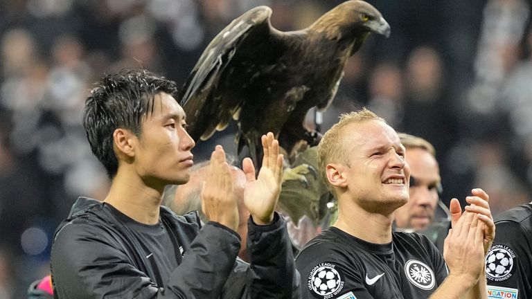 Frankfurt's Sebastian Rode, right, and Frankfurt's Daichi Kamada, left, celebrates with the club eagle behind after winning the Champions League Group D soccer match between Eintracht Frankfurt and Olympique de Marseille in Frankfurt, Germany, Wednesday, Oct. 26, 2022. (AP Photo/Martin Meissner)