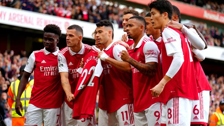 Arsenal's Gabriel Martinelli (centre) holds up former team-mate Pablo Mari's shirt as he celebrates scoring their side's first goal of the game
