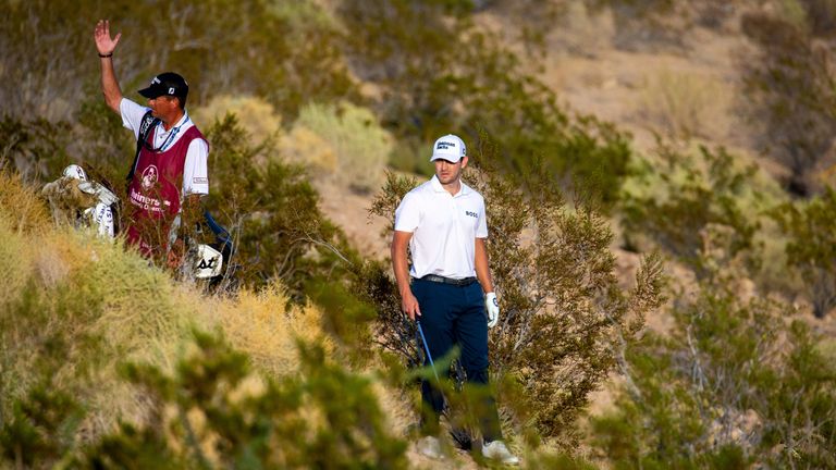 LAS VEGAS, NV - OCTOBER 09: Patrick Cantlay and his caddy ask for PGA official to return to discuss his lie in the arroyo on the eighteenth hole during the final round of the Shriners Children's Open on October 9, 2022, at TPC Summerlin in Las Vegas, NV. (Photo by Matthew Bolt/Icon Sportswire) (Icon Sportswire via AP Images)


