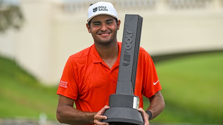 Eugenio Lopez-Chacarra from Spain holds up the winner's trophy after his victory at the LIV Golf Invitational Bangkok 2022. (AP Photo/Kittinun Rodsupan)