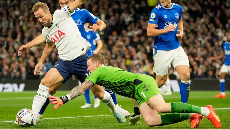 Everton's goalkeeper Jordan Pickford dives for a save but ends up bringing down Tottenham's Harry Kane