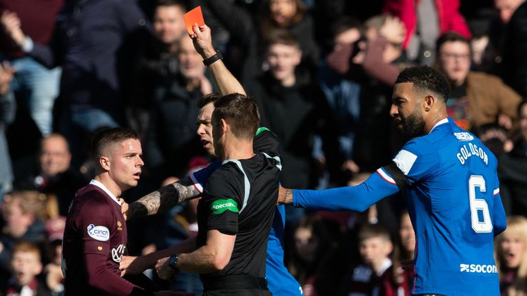 Hearts' Cammy Devlin is shown a straight red card
