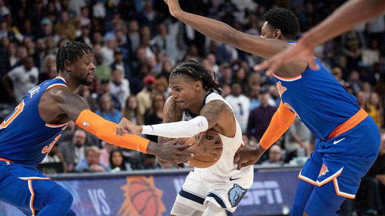 Memphis Grizzlies guard Ja Morant drives between New York Kicks forward Julius Randle and forward RJ Barrett 
