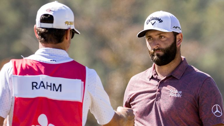 Jon Rahm, of Spain, hands a club to his caddie after putting on the first green during the final round of the CJ Cup golf tournament Sunday, Oct. 23, 2022, in Ridgeland, S.C. (AP Photo/Stephen B. Morton) 