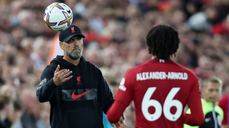 LIVERPOOL, ENGLAND - AUGUST 15: Liverpool Manager, Jurgen Klopp throws the ball to Trent Alexander-Arnold of Liverpool during the Premier League match between Liverpool FC and Crystal Palace at Anfield on August 15, 2022 in Liverpool, England. (Photo by Clive Brunskill/Getty Images)
