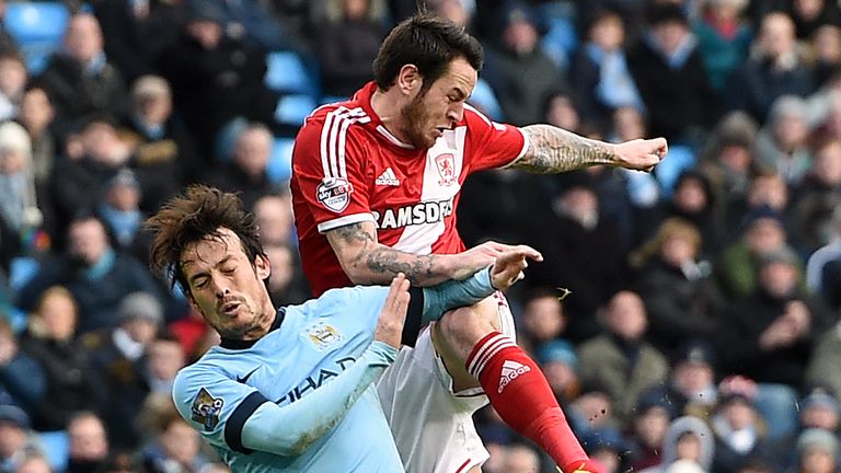 Manchester City&#39;s David Silva (left) and Middlesbrough&#39;s Lee Tomlin battle for the ball during the FA Cup Fourth Round match at the Etihad Stadium, Manchester. PRESS ASSOCIATION Photo. Picture date: Saturday January 24, 2015. See PA story SOCCER Man City. Photo credit should read: Martin Rickett/PA Wire. RESTRICTIONS: Editorial use only. Maximum 45 images during a match. No video emulation or promotion as &#39;live&#39;. No use in games, competitions, merchandise, betting or single club/player services. No use with unofficial audio, video, data, fixtures or club/league logos.