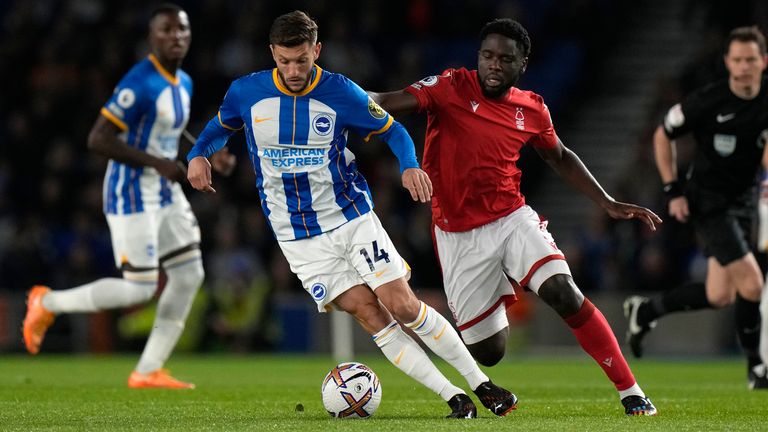 Nottingham Forest's Orel Mangala, right, challenges for the ball with Brighton's Adam Lallana