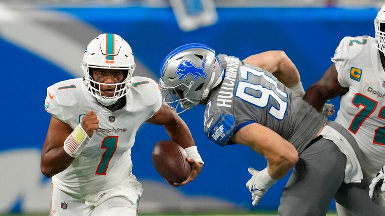 Miami Dolphins quarterback Tua Tagovailoa (1) is pressured by Detroit Lions defensive end Aidan Hutchinson (97) during the second half of an NFL football game, Sunday, Oct. 30, 2022, in Detroit. (AP Photo/Paul Sancya)