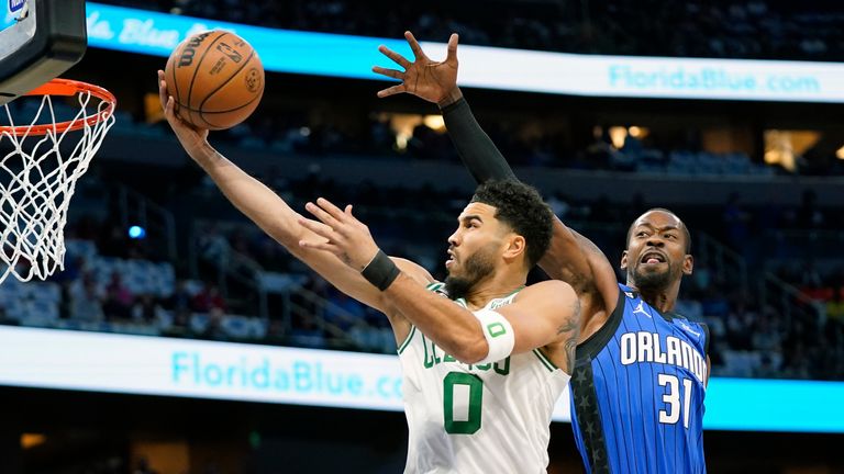 Boston Celtics&#39; Jayson Tatum (0) shoots as he gets past Orlando Magic&#39;s Terrence Ross (31) during the first half of an NBA basketball game, Saturday, Oct. 22, 2022, in Orlando, Fla. (AP Photo/John Raoux)


