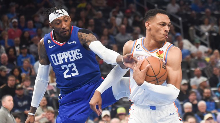 Los Angeles Clippers forward Robert Covington, left, tries to get the ball away from Oklahoma City Thunder forward Darius Bazley, right, in the second half of an NBA basketball game, Thursday, Oct. 27, 2022, in Oklahoma City. (AP Photo/Kyle Phillips)


