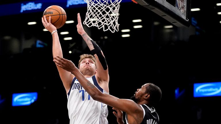 Dallas Mavericks guard Luka Doncic (77) shoots against Brooklyn Nets forward Kevin Durant (7) during the first half of an NBA basketball game, Thursday, Oct. 27, 2022, in New York. (AP Photo/John Minchillo)


