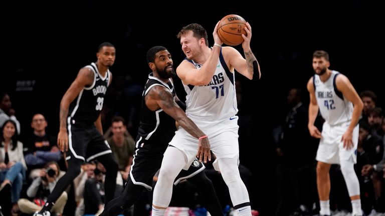 Brooklyn Nets guard Kyrie Irving (11) defends against Dallas Mavericks guard Luka Doncic (77) during overtime of an NBA basketball game, Thursday, Oct. 27, 2022, in New York. (AP Photo/John Minchillo)


