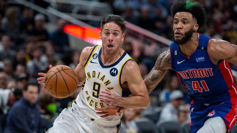 Indiana Pacers guard T.J. McConnell (9) drives the ball past the defense of Detroit Pistons forward Saddiq Bey (41) during an NBA basketball game in Indianapolis, Saturday, Oct. 22, 2022. (AP Photo/Doug McSchooler)


