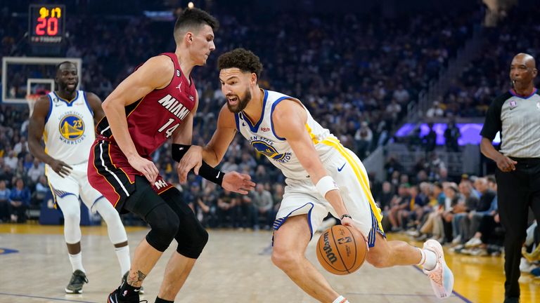 Golden State Warriors guard Klay Thompson, right, drives to the basket against Miami Heat guard Tyler Herro during the first half of an NBA basketball game in San Francisco, Thursday, Oct. 27, 2022. (AP Photo/Jeff Chiu)


