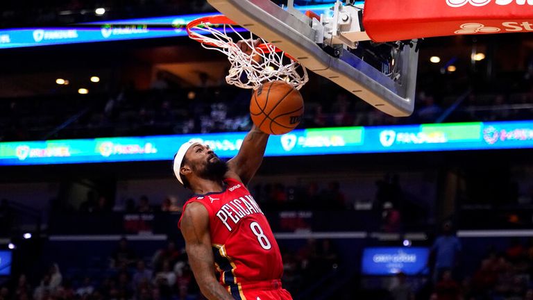 New Orleans Pelicans forward Naji Marshall (8) slam dunks in the second half of an NBA basketball game against the Dallas Mavericks in New Orleans, Tuesday, Oct. 25, 2022. The Pelicans won 113-111. (AP Photo/Gerald Herbert)