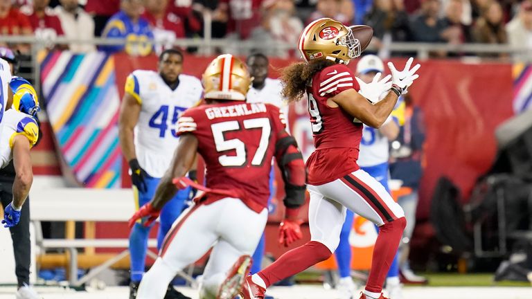 San Francisco 49ers safety Talanoa Hufanga, right, returns an interception for a touchdown during the second half of an NFL football game against the Los Angeles Rams in Santa Clara, Calif., Monday, Oct. 3, 2022.