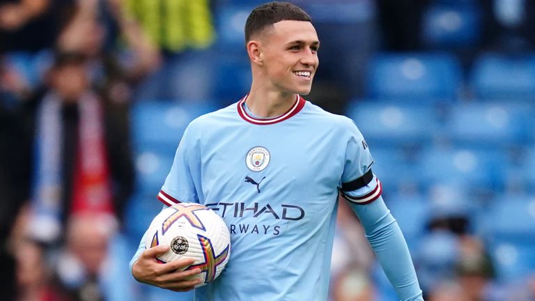 Phil Foden celebrates with the match ball after Man City's 6-3 derby win over Man Utd