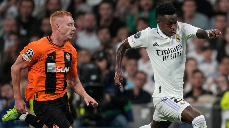 Real Madrid's Vinicius Junior, right, runs with the ball ahead of Shakhtar's Yukhym Konoplya during the Champions League group F soccer match between Real Madrid and Shakhtar Donetsk at the Santiago Bernabeu stadium in Madrid, Wednesday, Oct. 5, 2022. (AP Photo/Bernat Armangue)