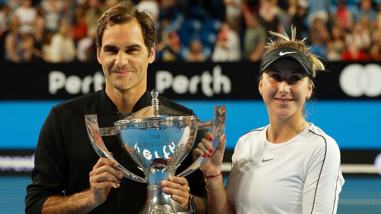 Switzerland's Roger Federer and Belinda Bencic hold the trophy after winning the final against Alexander Zverev and Angelique Kerber of Germany at the Hopman Cup in Perth, Australia, Saturday Jan. 5, 2019. 