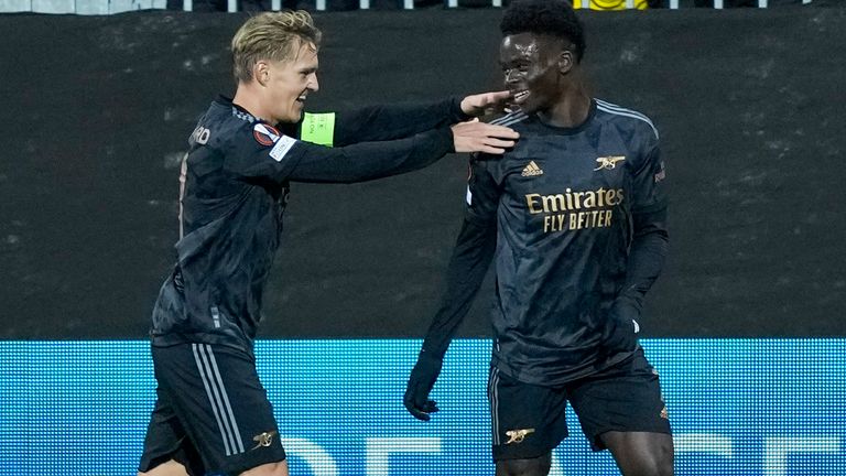 Arsenal's Bukayo Saka, right, celebrates scoring their side's first goal of the game