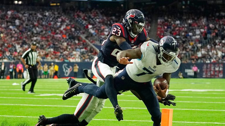 Tennessee Titans quarterback Malik Willis (7) is pushed out of bounds short of the goal line by Houston Texans safety Eric Murray (23) during the second half of an NFL football game Sunday, Oct. 30, 2022, in Houston. (AP Photo/Eric Gay)