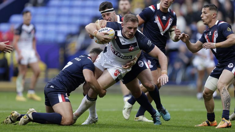 England v France - Rugby League World Cup - Group A - University of Bolton Stadium
England's Tom Burgess (centre) is tackled during the Rugby League World Cup group A match at the University of Bolton Stadium, Bolton. Picture date: Saturday October 22, 2022.