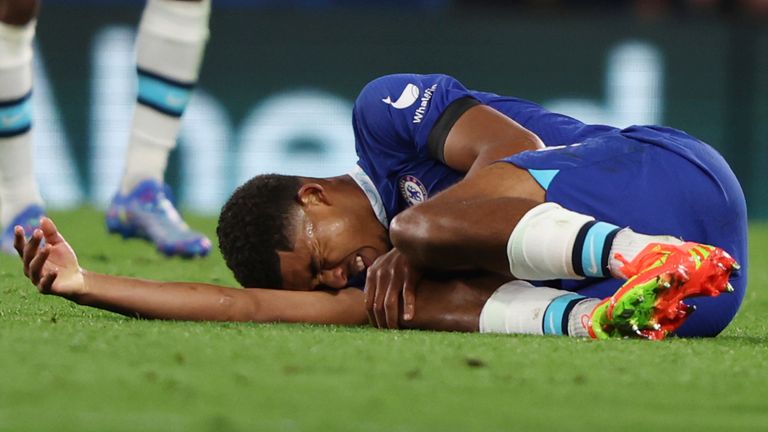 Chelsea&#39;s Wesley Fofana lies injured on the ground during the match against Milan