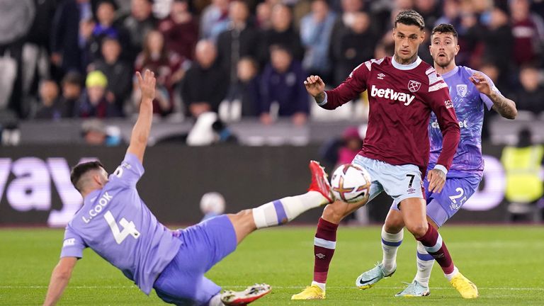 Lewis Cook challenges for the ball